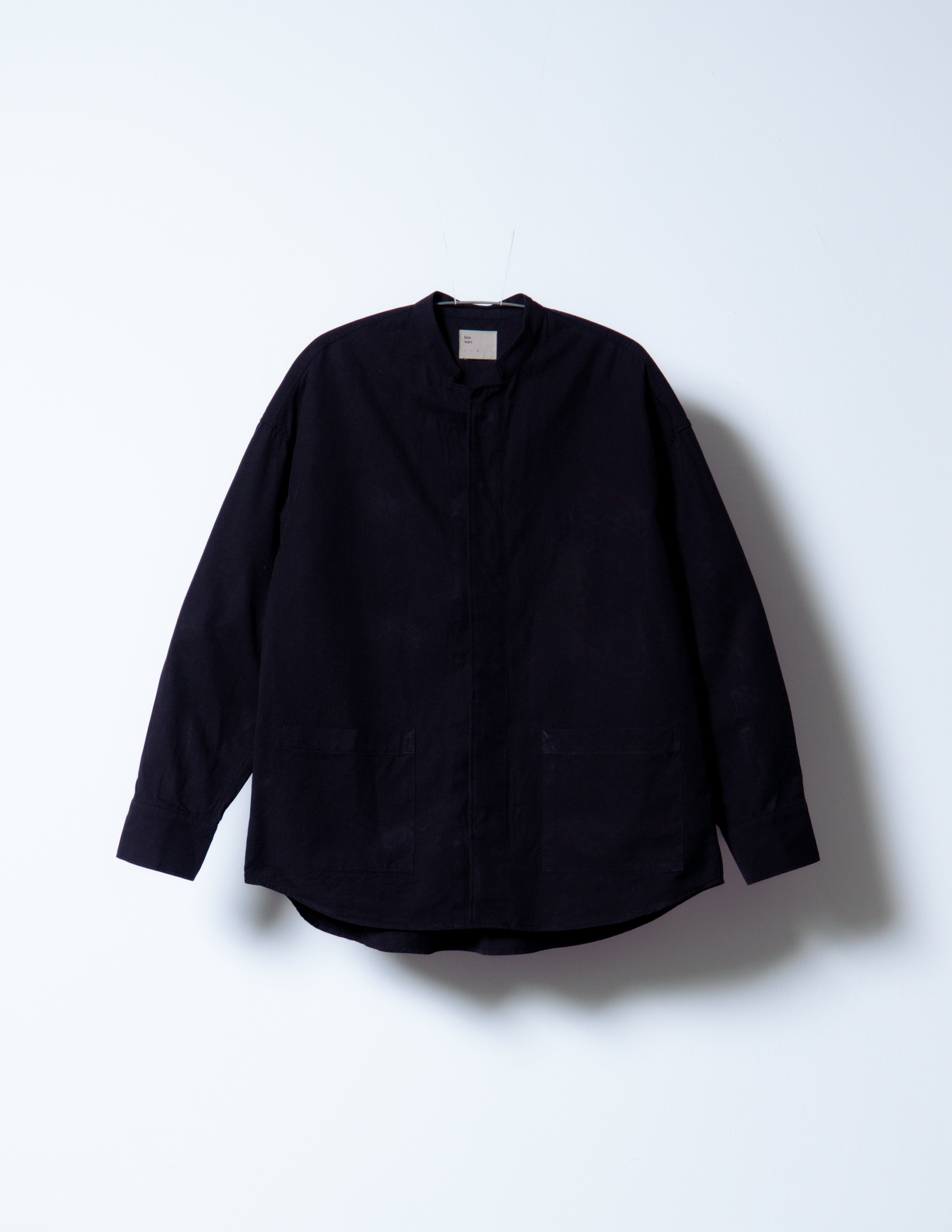 A Eckhaus Latta Shirt pictured on a model in front of a white background. The title of the product is Eckhaus Latta Eclipse Turtleneck - Stone and the image was taken by 199A®.