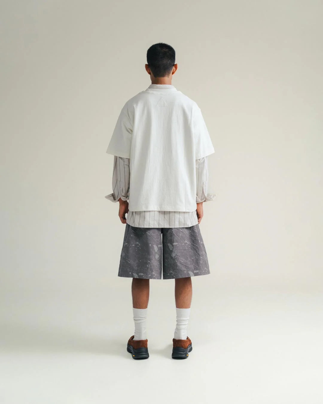A Eckhaus Latta Shirt pictured on a model in front of a white background. The title of the product is Eckhaus Latta Eclipse Turtleneck - Stone and the image was taken by 199A®.