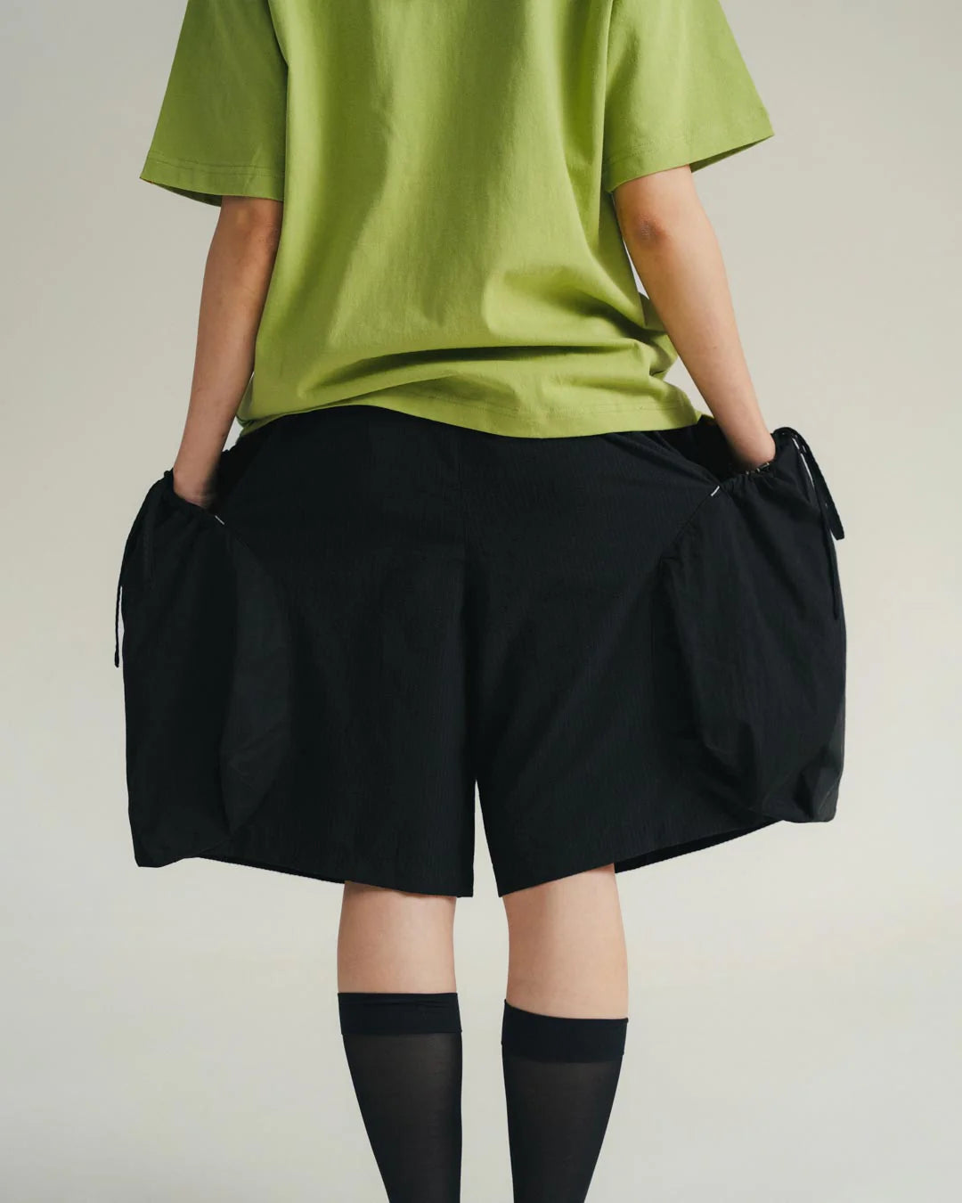 A Eckhaus Latta Shirt pictured on a model in front of a white background. The title of the product is Eckhaus Latta Eclipse Turtleneck - Stone and the image was taken by 199A®.