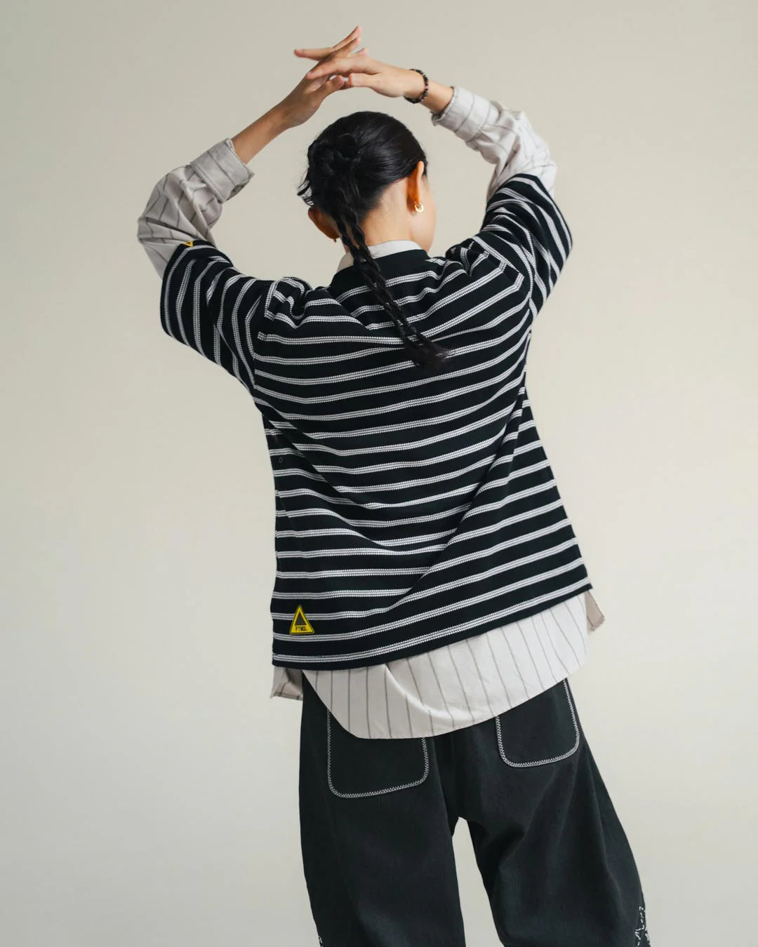 A Eckhaus Latta Shirt pictured on a model in front of a white background. The title of the product is Eckhaus Latta Eclipse Turtleneck - Stone and the image was taken by 199A®.