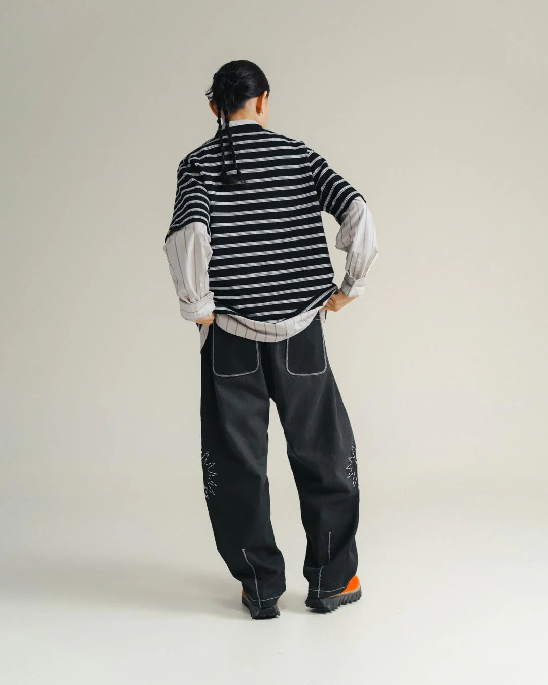 A Eckhaus Latta Shirt pictured on a model in front of a white background. The title of the product is Eckhaus Latta Eclipse Turtleneck - Stone and the image was taken by 199A®.