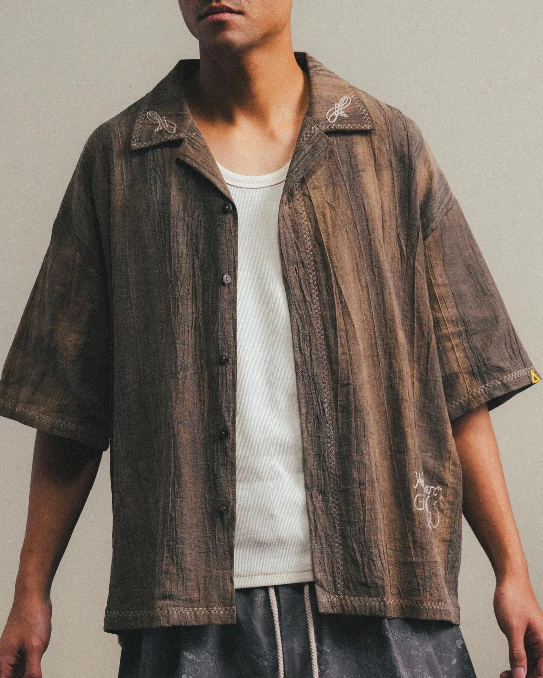 A Eckhaus Latta Shirt pictured on a model in front of a white background. The title of the product is Eckhaus Latta Eclipse Turtleneck - Stone and the image was taken by 199A®.
