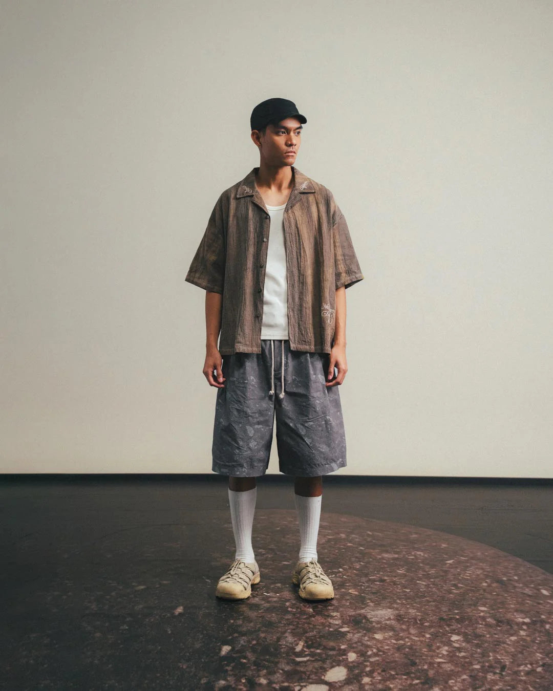 A Eckhaus Latta Shirt pictured on a model in front of a white background. The title of the product is Eckhaus Latta Eclipse Turtleneck - Stone and the image was taken by 199A®.