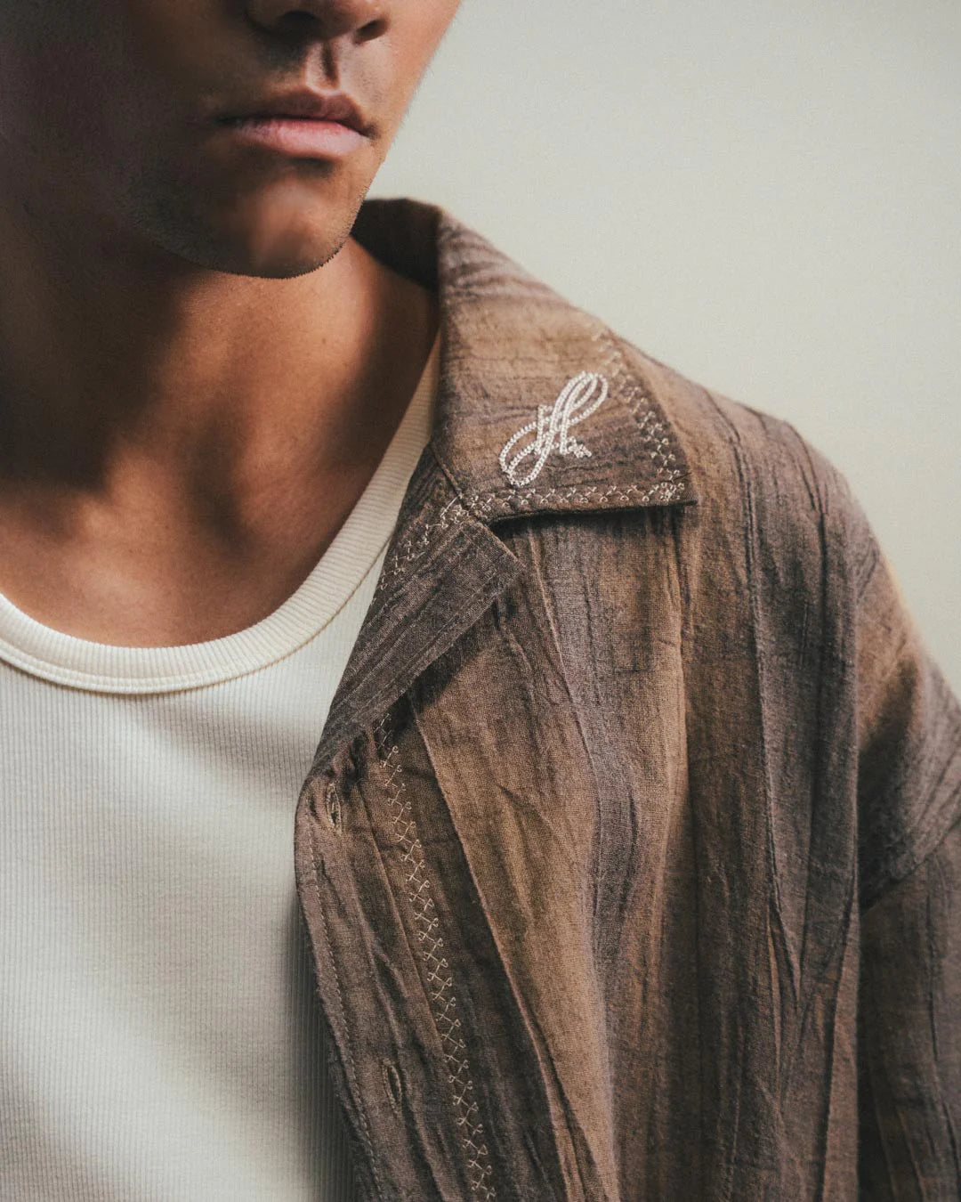 A Eckhaus Latta Shirt pictured on a model in front of a white background. The title of the product is Eckhaus Latta Eclipse Turtleneck - Stone and the image was taken by 199A®.