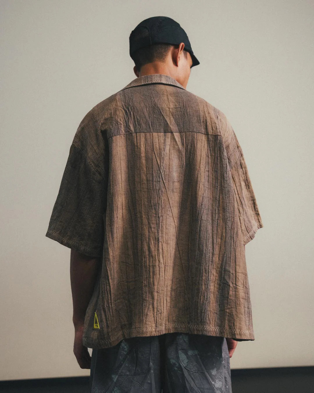 A Eckhaus Latta Shirt pictured on a model in front of a white background. The title of the product is Eckhaus Latta Eclipse Turtleneck - Stone and the image was taken by 199A®.