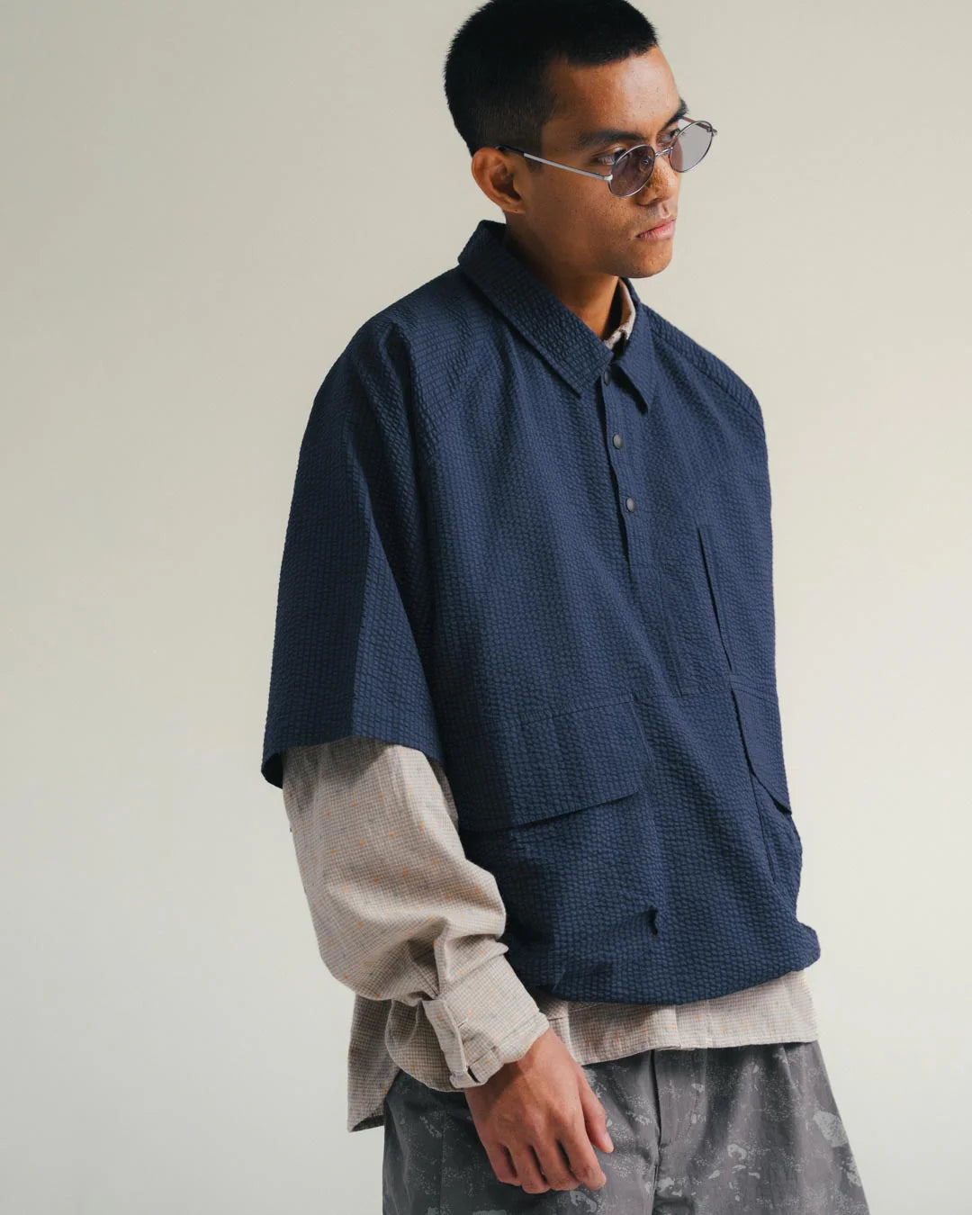 A Eckhaus Latta Shirt pictured on a model in front of a white background. The title of the product is Eckhaus Latta Eclipse Turtleneck - Stone and the image was taken by 199A®.