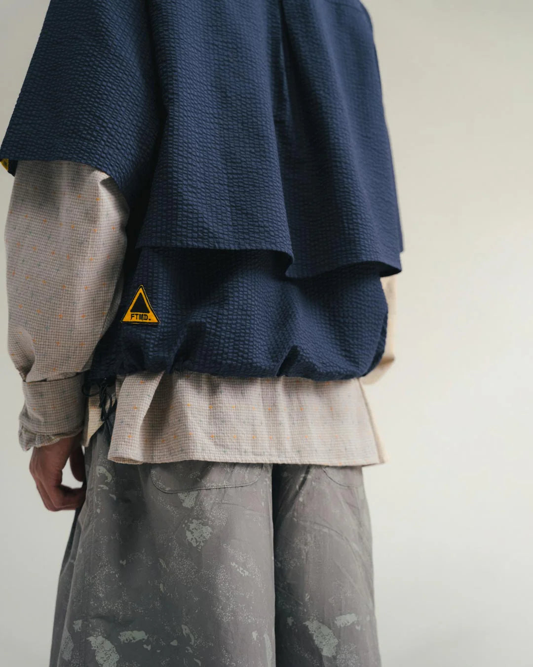 A Eckhaus Latta Shirt pictured on a model in front of a white background. The title of the product is Eckhaus Latta Eclipse Turtleneck - Stone and the image was taken by 199A®.