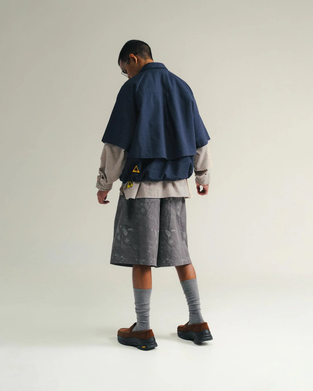 A Eckhaus Latta Shirt pictured on a model in front of a white background. The title of the product is Eckhaus Latta Eclipse Turtleneck - Stone and the image was taken by 199A®.
