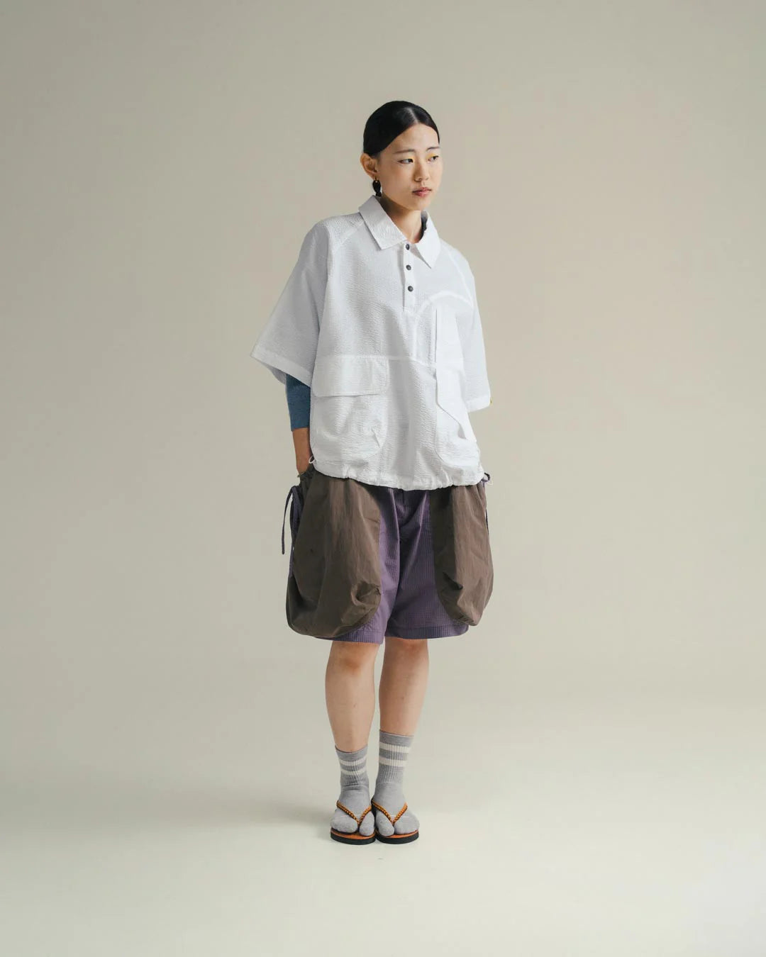 A Eckhaus Latta Shirt pictured on a model in front of a white background. The title of the product is Eckhaus Latta Eclipse Turtleneck - Stone and the image was taken by 199A®.