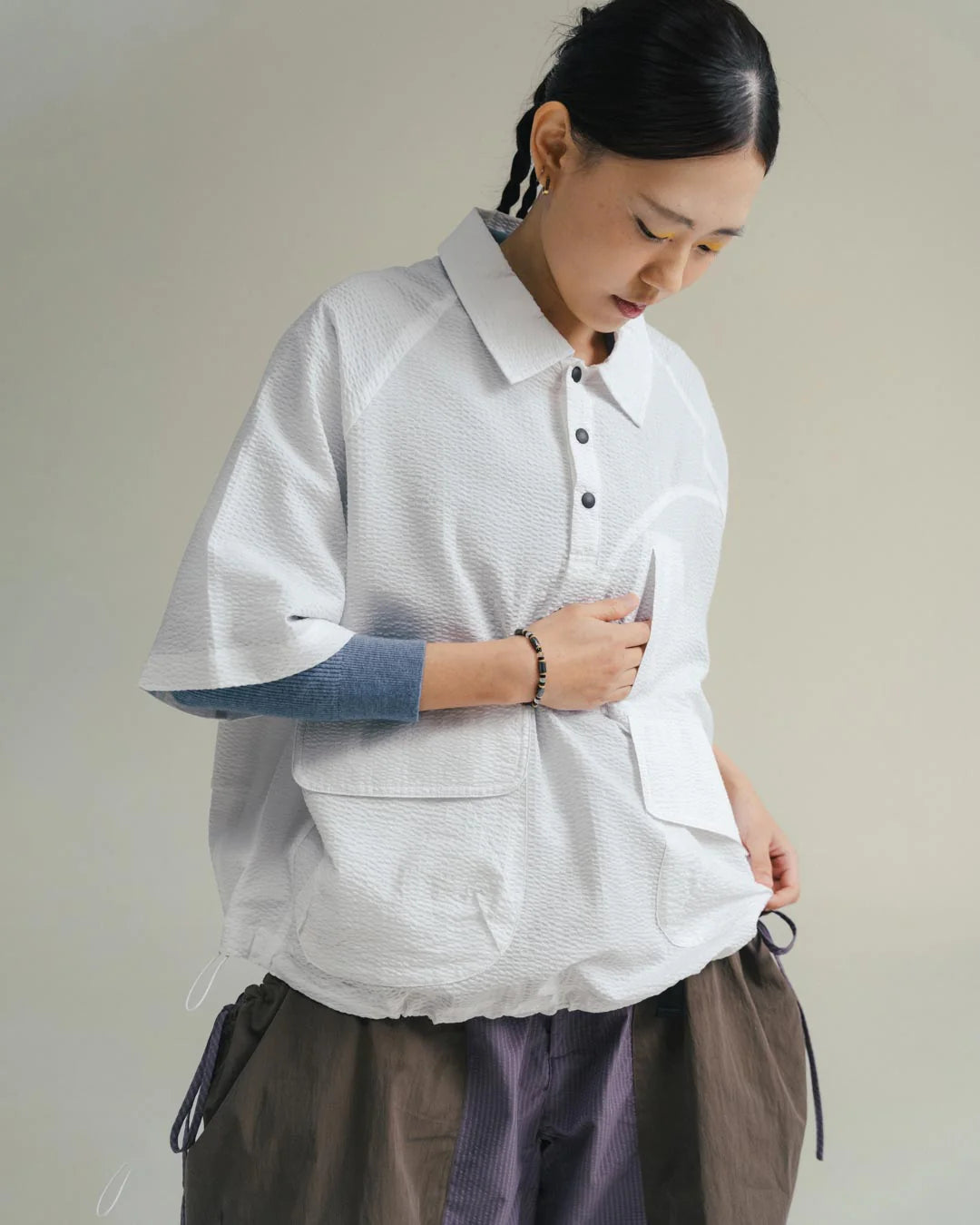 A Eckhaus Latta Shirt pictured on a model in front of a white background. The title of the product is Eckhaus Latta Eclipse Turtleneck - Stone and the image was taken by 199A®.