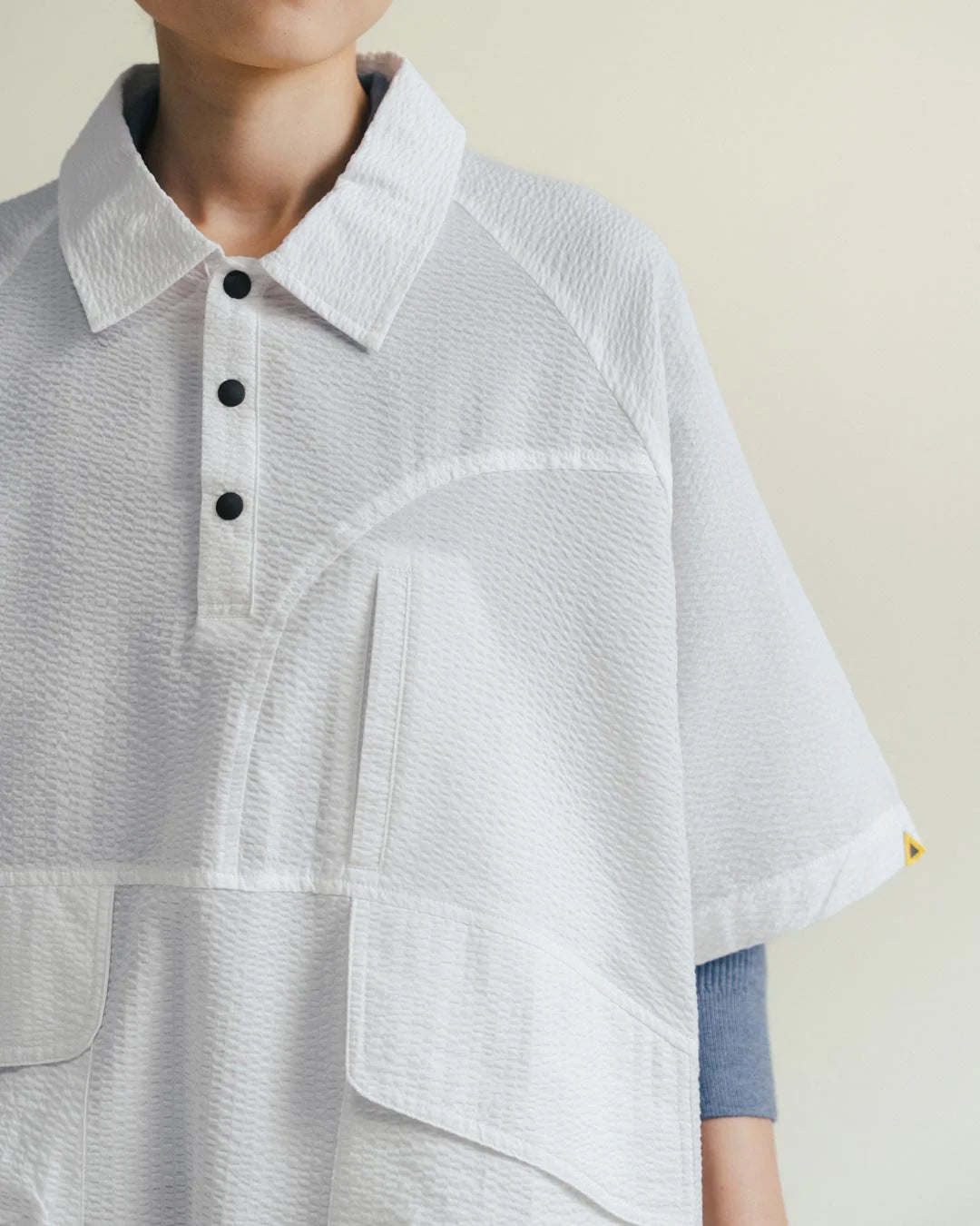A Eckhaus Latta Shirt pictured on a model in front of a white background. The title of the product is Eckhaus Latta Eclipse Turtleneck - Stone and the image was taken by 199A®.