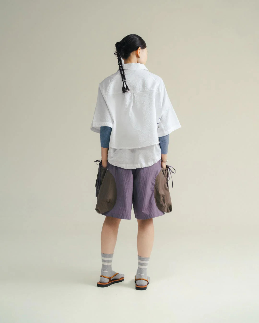 A Eckhaus Latta Shirt pictured on a model in front of a white background. The title of the product is Eckhaus Latta Eclipse Turtleneck - Stone and the image was taken by 199A®.