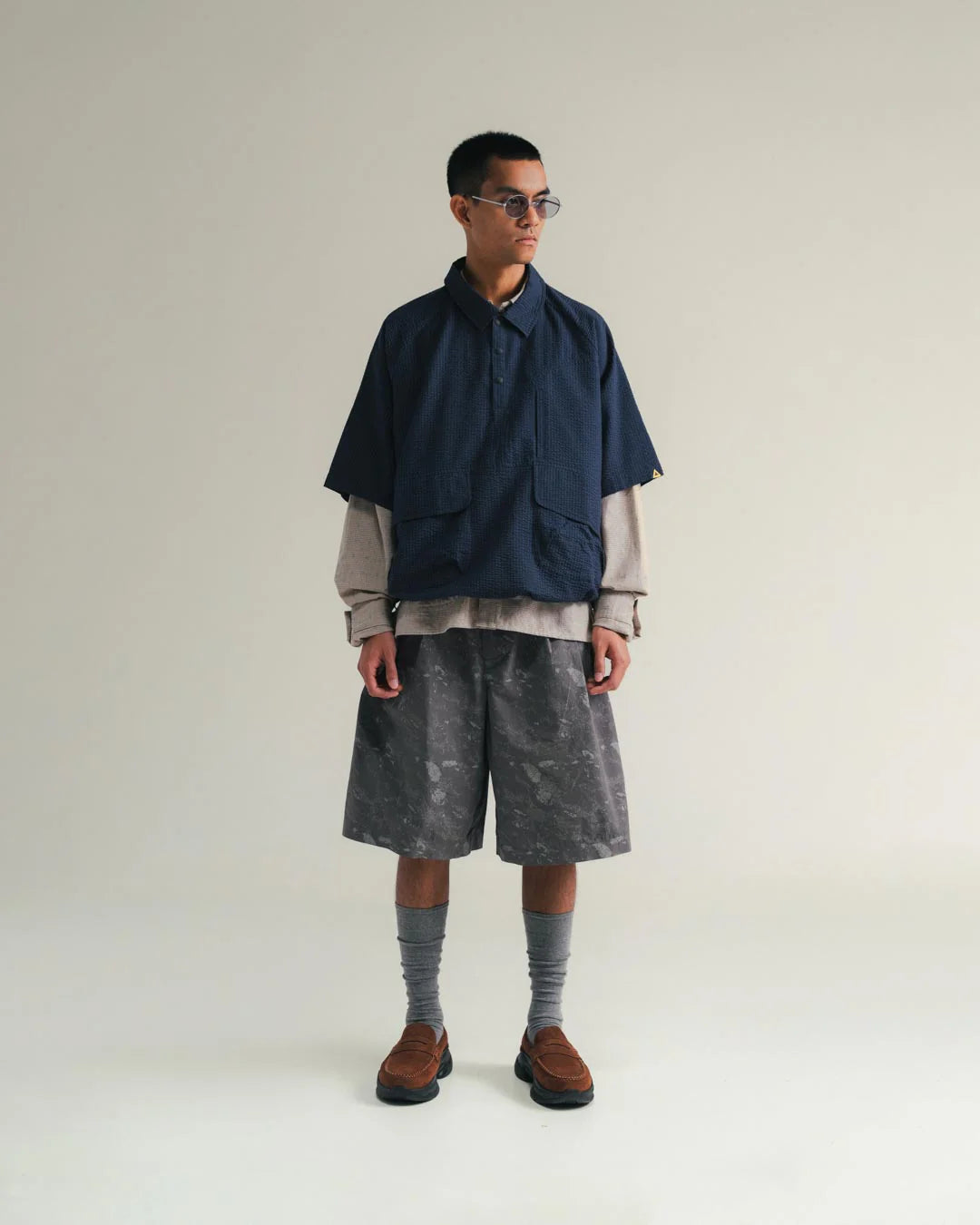 A Eckhaus Latta Shirt pictured on a model in front of a white background. The title of the product is Eckhaus Latta Eclipse Turtleneck - Stone and the image was taken by 199A®.