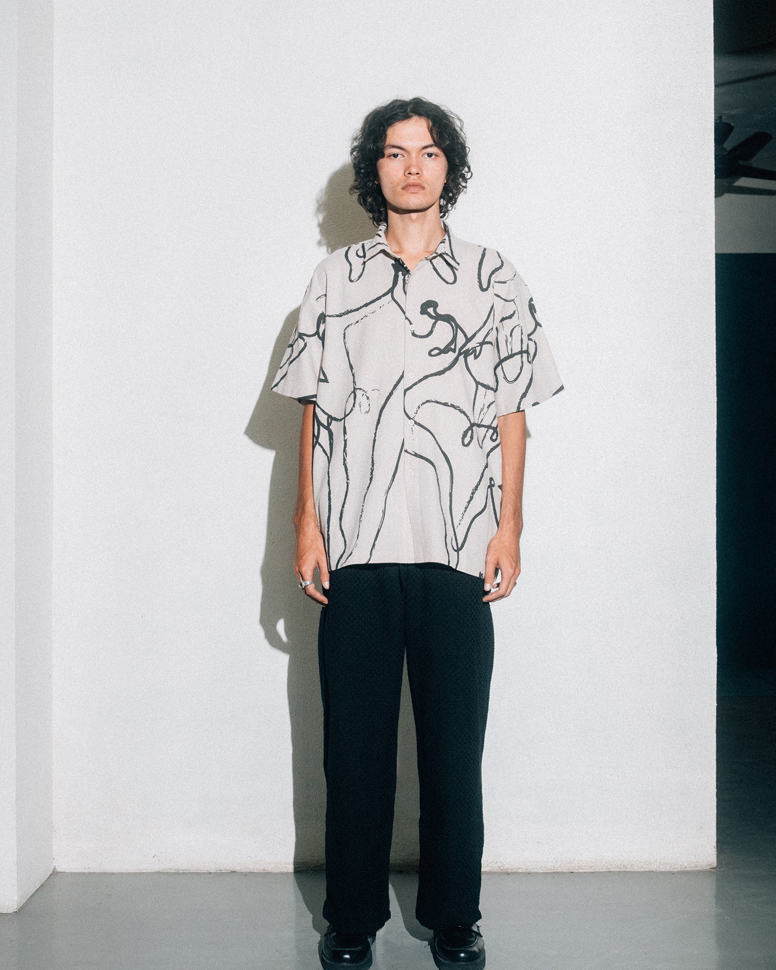 A Eckhaus Latta Shirt pictured on a model in front of a white background. The title of the product is Eckhaus Latta Eclipse Turtleneck - Stone and the image was taken by 199A®.