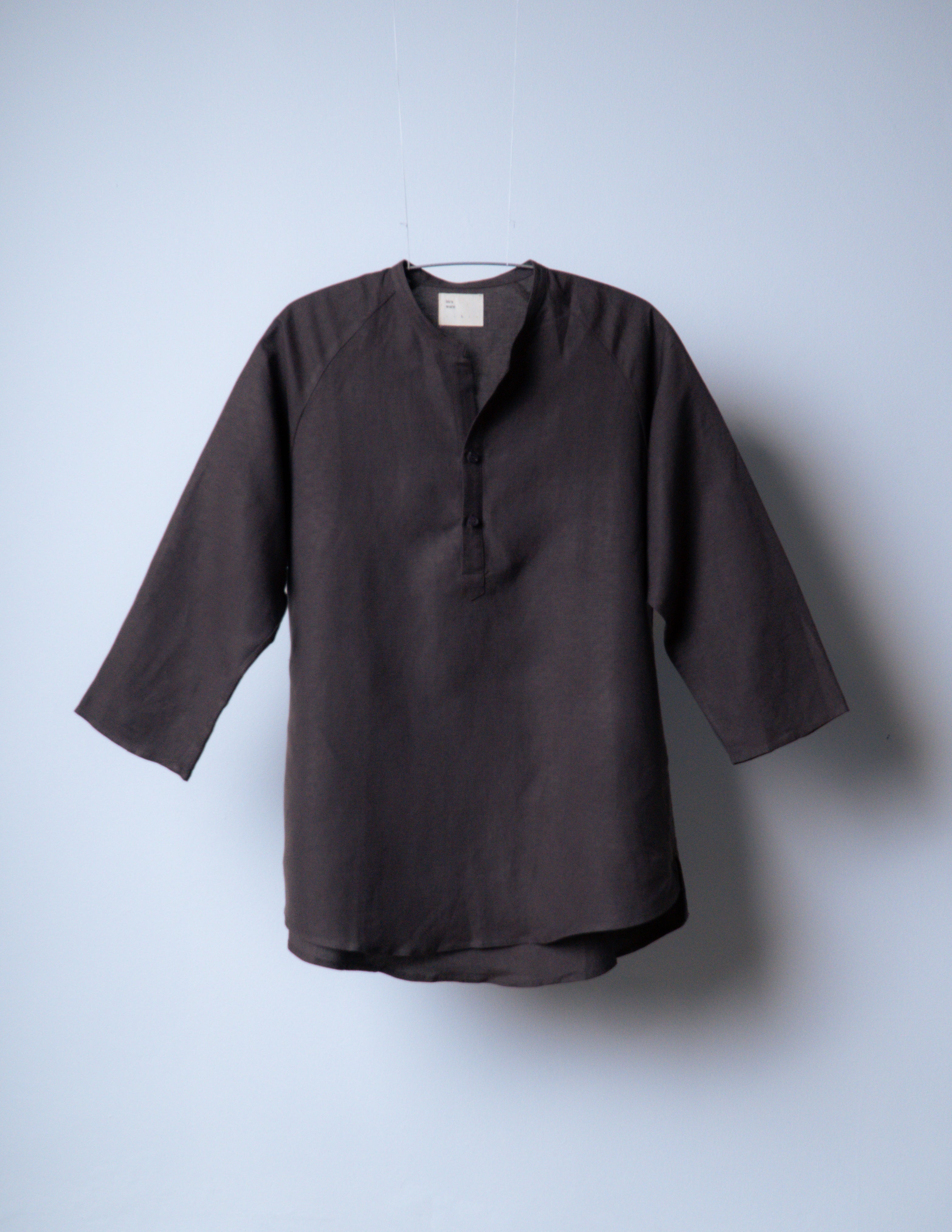 A Eckhaus Latta Shirt pictured on a model in front of a white background. The title of the product is Eckhaus Latta Eclipse Turtleneck - Stone and the image was taken by 199A®.