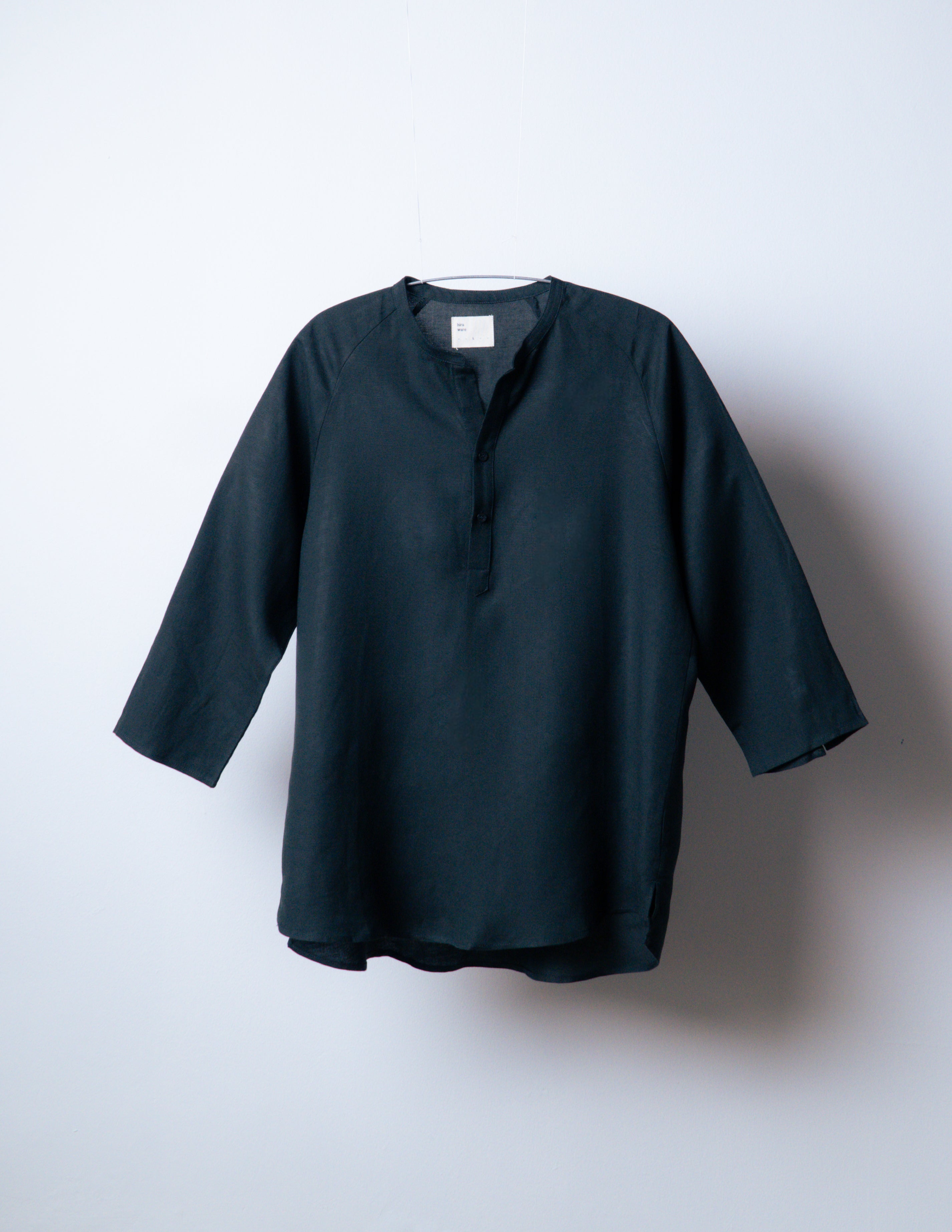 A Eckhaus Latta Shirt pictured on a model in front of a white background. The title of the product is Eckhaus Latta Eclipse Turtleneck - Stone and the image was taken by 199A®.