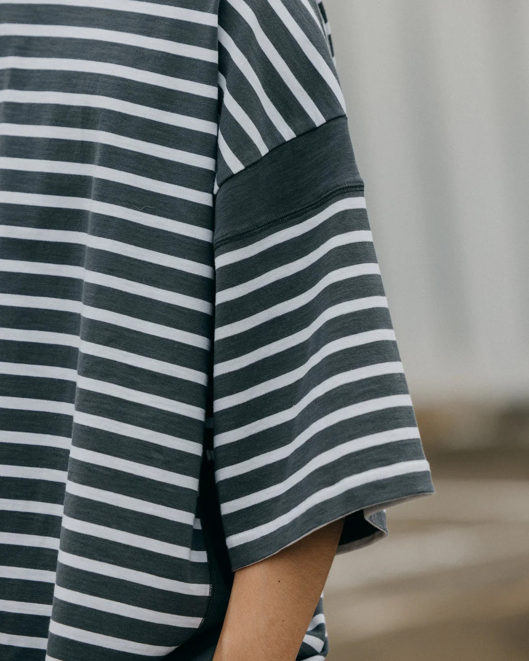 A Eckhaus Latta Shirt pictured on a model in front of a white background. The title of the product is Eckhaus Latta Eclipse Turtleneck - Stone and the image was taken by 199A®.