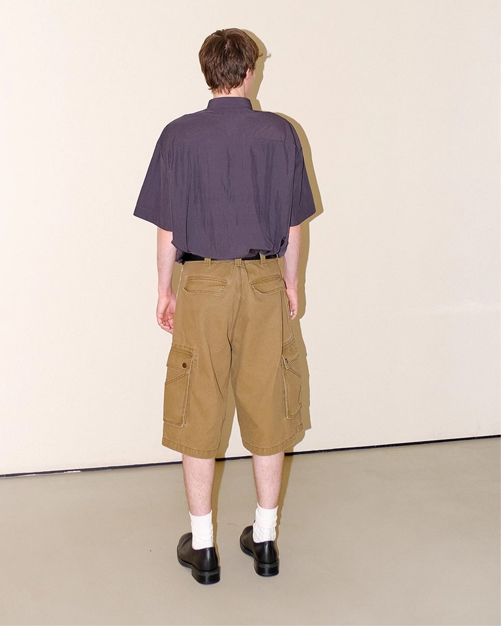 A Eckhaus Latta Shirt pictured on a model in front of a white background. The title of the product is Eckhaus Latta Eclipse Turtleneck - Stone and the image was taken by 199A®.