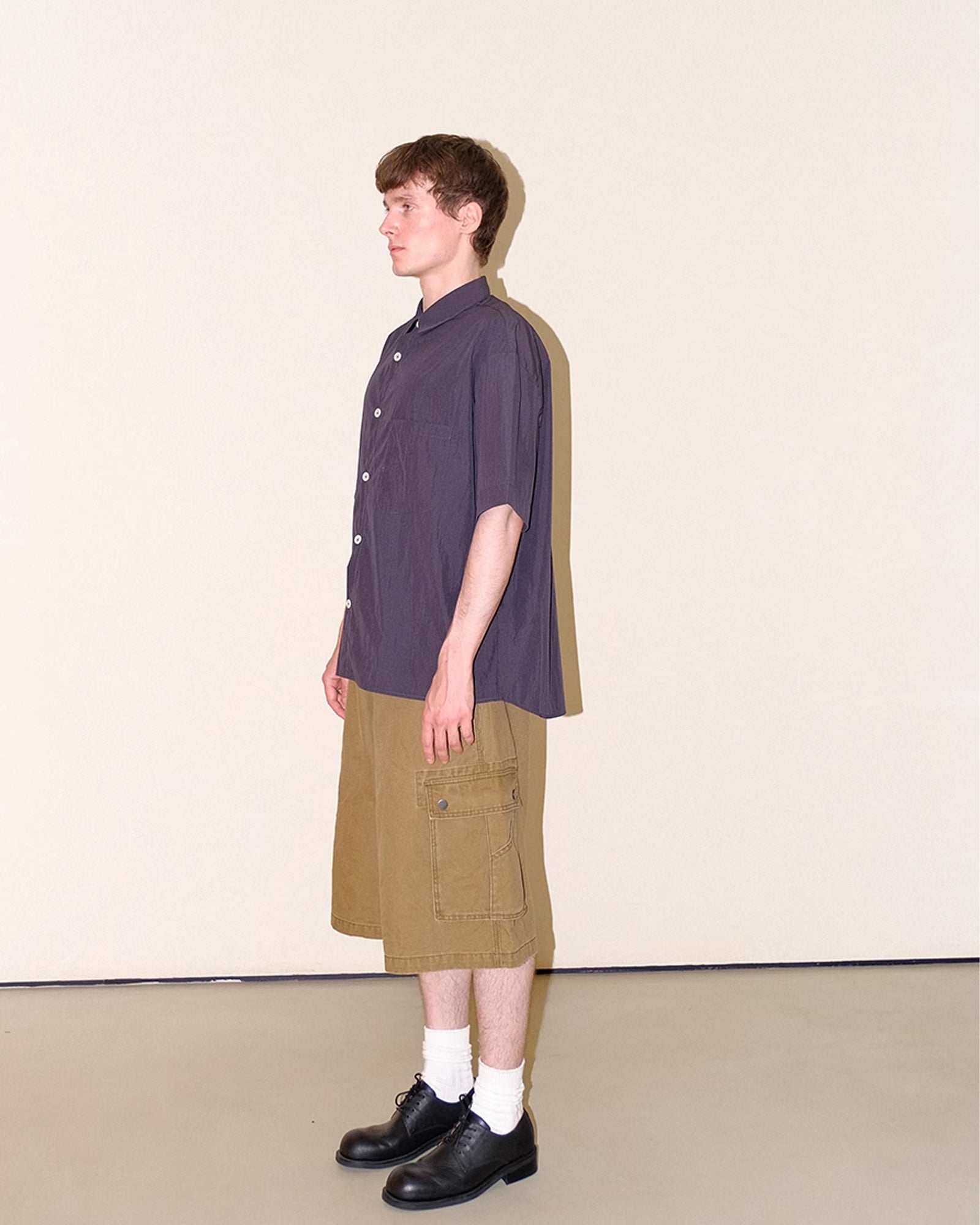 A Eckhaus Latta Shirt pictured on a model in front of a white background. The title of the product is Eckhaus Latta Eclipse Turtleneck - Stone and the image was taken by 199A®.