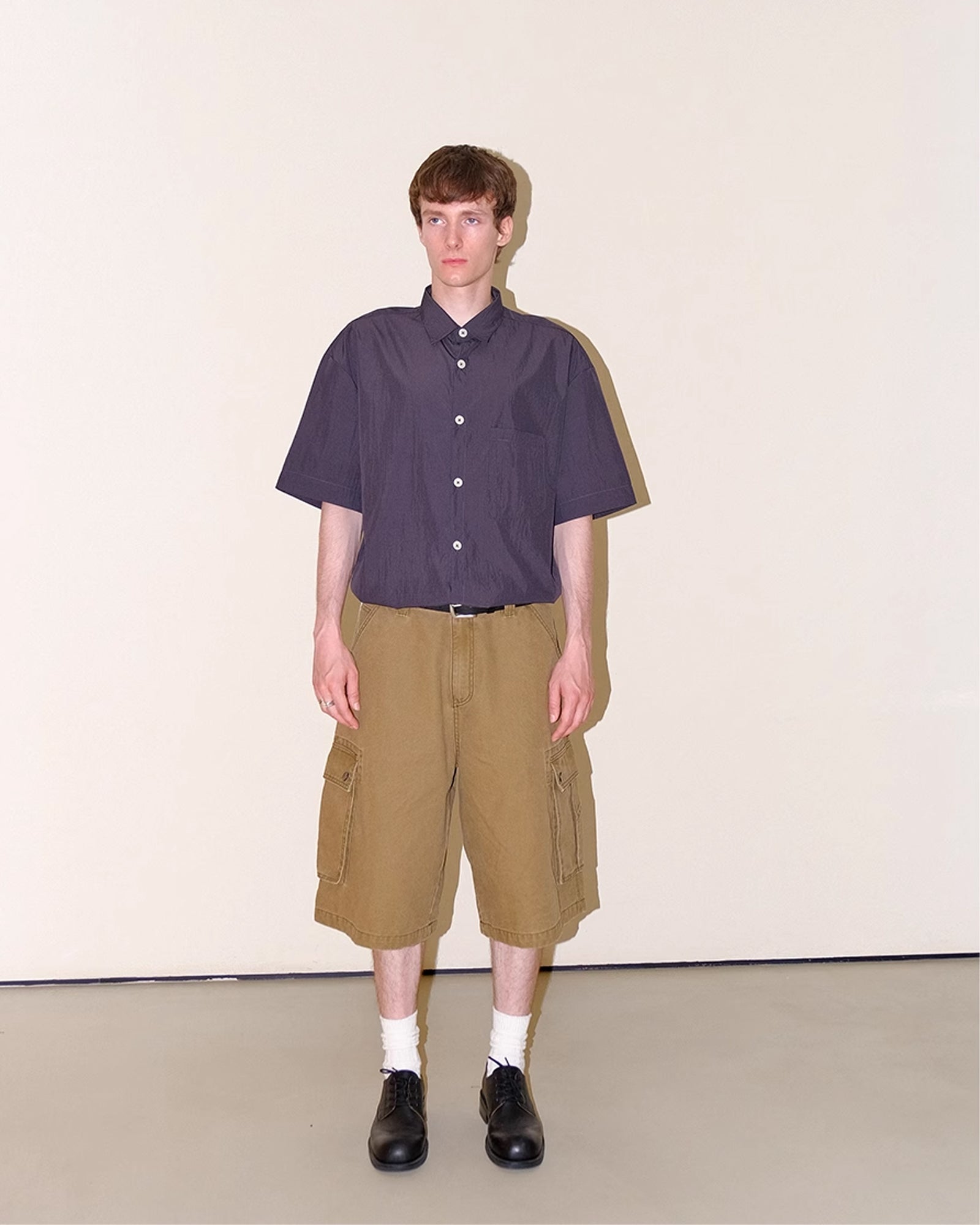 A Eckhaus Latta Shirt pictured on a model in front of a white background. The title of the product is Eckhaus Latta Eclipse Turtleneck - Stone and the image was taken by 199A®.